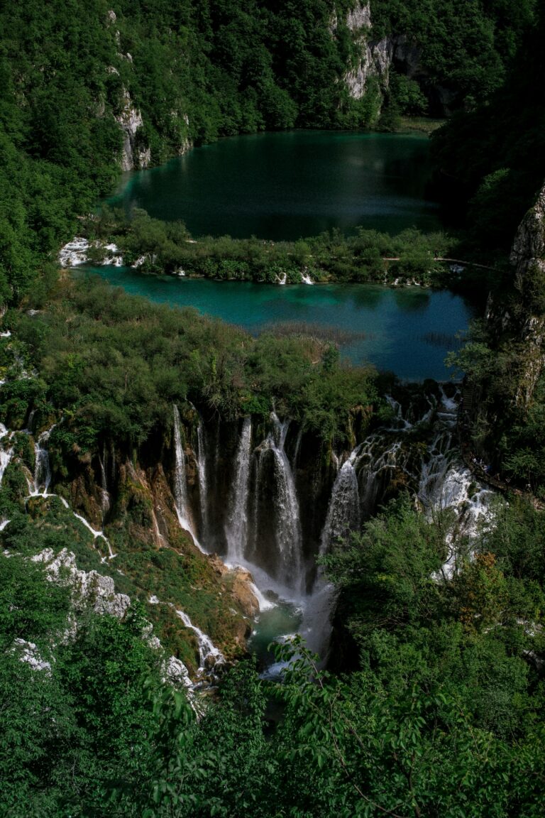 Breathtaking view of cascading waterfalls and lush landscape at Plitvice Lakes National Park.
