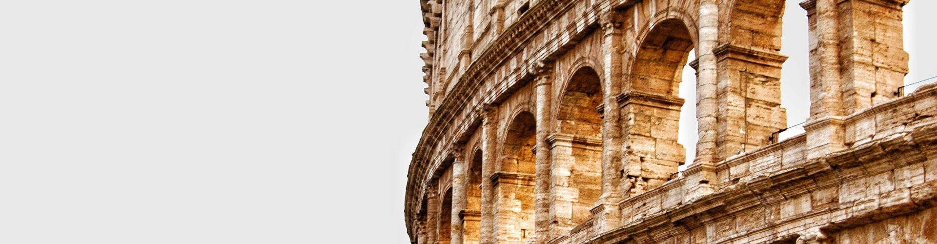 Detailed view of the Colosseum's arches in Rome, showcasing ancient Roman architecture.