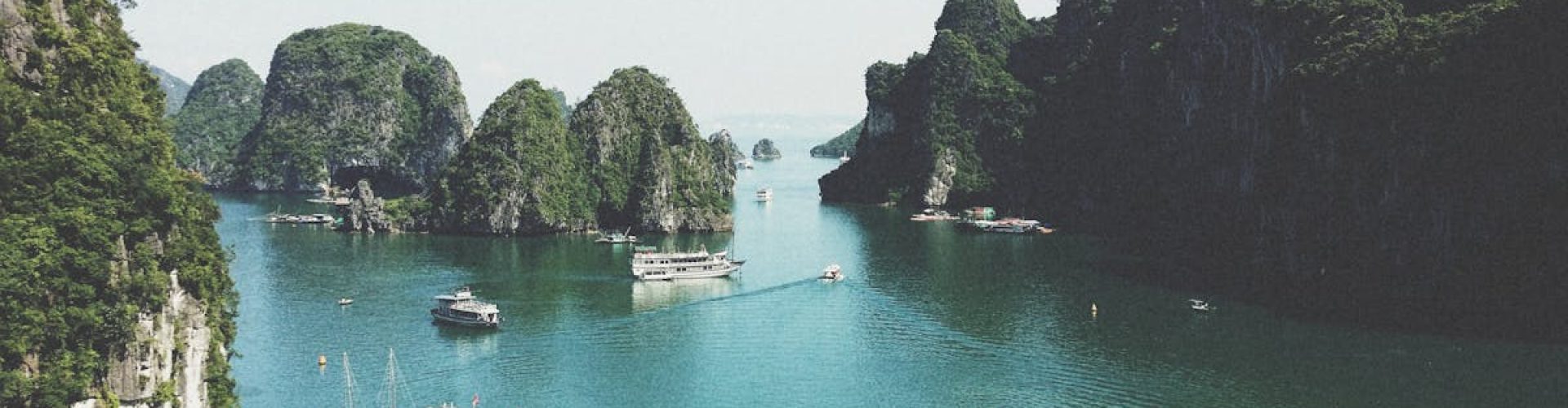 A breathtaking view of Halong Bay with boats navigating through limestone islands.